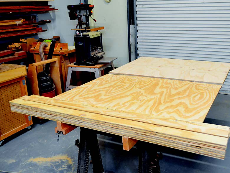 Using foam sheet and sawhorses to hold plywood sheet in place
