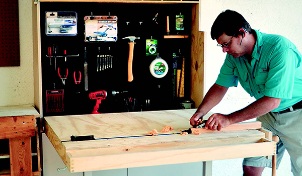Flip-down garage workbench