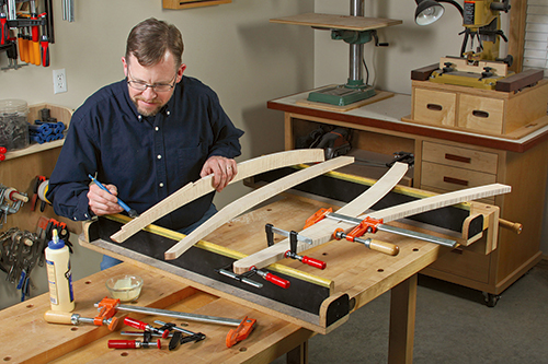 Adding glue to mirror leg spline joinery holes