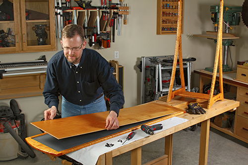 Install the mirror and back panel in the frame recess, and secure them with glass retainers and screws. Thread the pivot bolts through the stand holes and into the inserts to mount the mirror frame in the stand (inset).