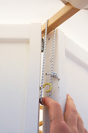 Attaching umbrella to portable gazebo base with cord