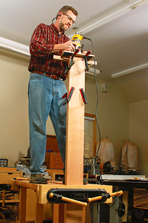 Standing on workbench to add mortise to end of bed rail