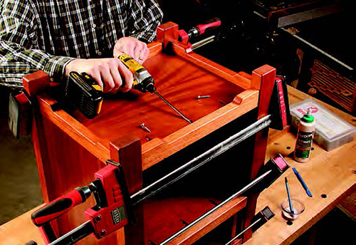 Pocket screws driven from the bottom panel and fixed shelf into the front bottom and center rails strengthen these joints and ensure that the visible seams are tight from above.