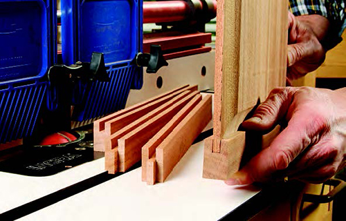 A large raised-panel cutter with a cove shape reduced the door’s 1/2"-thick panel to fit the frame grooves while also adding a decorative profile around its face. Take several rounds of deepening passes for safety and to help minimize burn marks.
