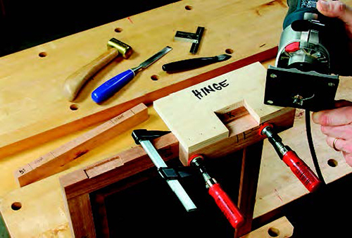 A simple shop-made jig makes quick, precise work of cutting the hinge-leaf mortises. Its opening matches the exact hinge-leaf proportions.