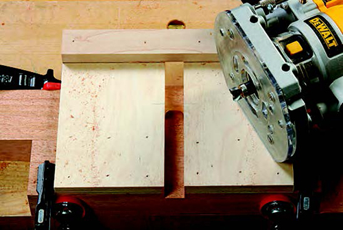 The author used a piloted hinge-mortising bit (see inset) to mill these 1/4"-deep, 1"-long cuts. A back stop on the jig limited the cutting length.