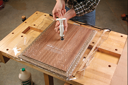 A heavy-duty vacuum bag, one-way valve and hand pump made easy work of pressing the side panel veneers flat against their substrates.