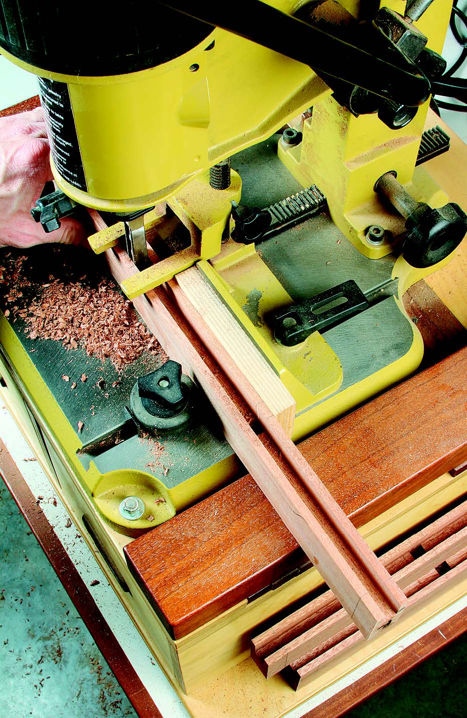 Chop 1/2" x 1/2" mortises in the side rails to accept the side slat tenons.