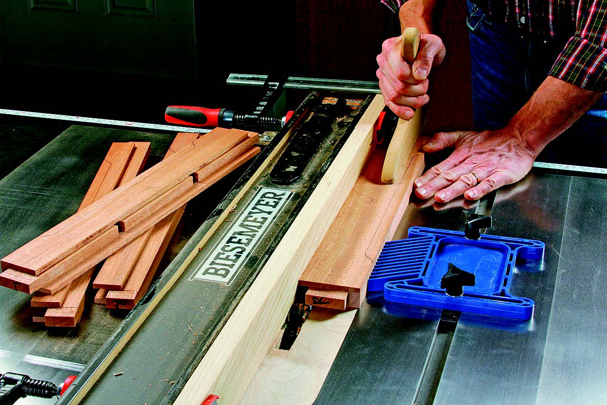 Saw away the inside walls of the side rail grooves with a wide dado blade to create rabbets for housing the top and bottom web frames. These rabbets should measure 3/4" wide and 1/4" deep.