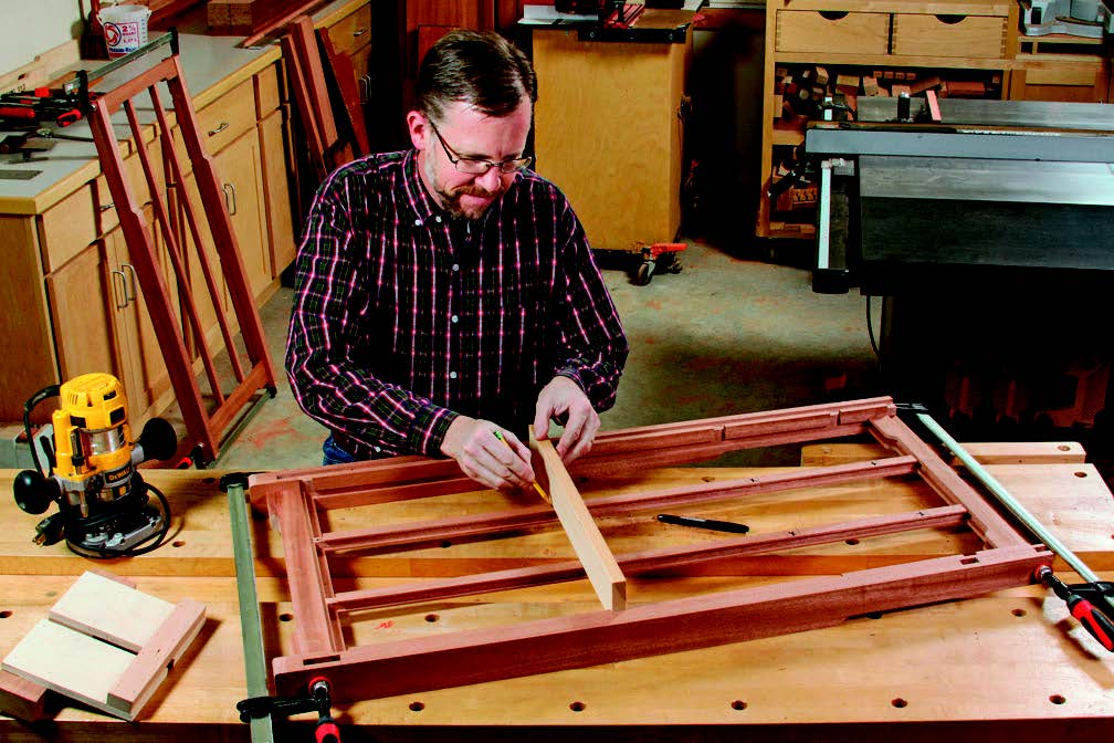 Dry-fitting a side assembly together is the time to mark the side slats for their web frame dadoes: fit a piece of scrap in the leg dadoes, and draw reference lines off of it. It's a good way to avoid measuring errors.