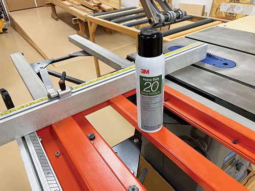 Spraying adhesive on crosscut fence to add stickiness