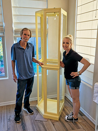 Bill Blix and his daughter with a display case
