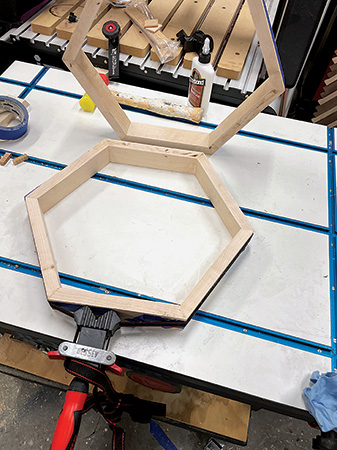 Installing pieces for hexagonal decoration in tall table