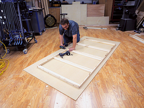 Laying out bed frame parts for Murphy bed