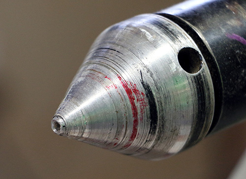 Lathe center with hole for holding blank