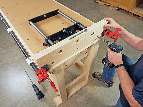 Screwing tail vise into end of workbench