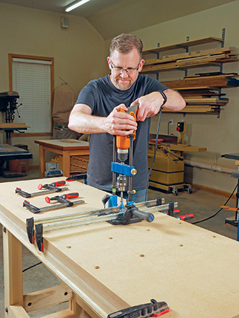 Drilling dog holes in workbench surface