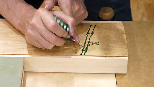Applying colored resin in decorative bamboo carving
