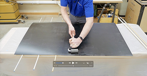 Rolling plastic laminate onto tabletop