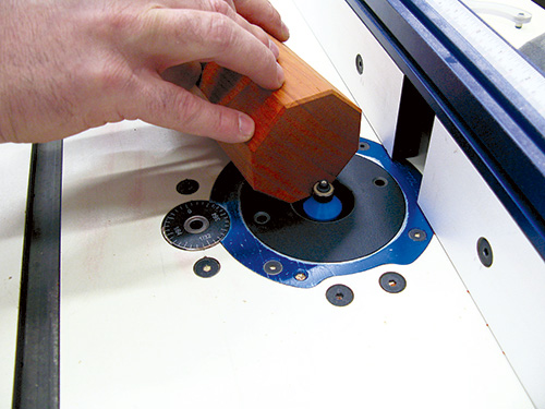 Rounding off edges of kubb game pieces with chamfering bit on router