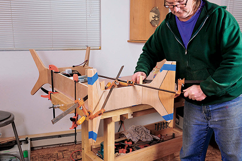 Cutoff scraps serve as clamping cauls that provide secure clamping surfaces when the legs are glued to the drawer frame.