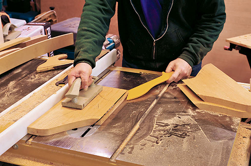The straight side of each leg blank (where it joins the table) is bevel cut at 45˚ on the table saw.
