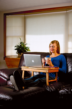 Sitting with folding desk over lap