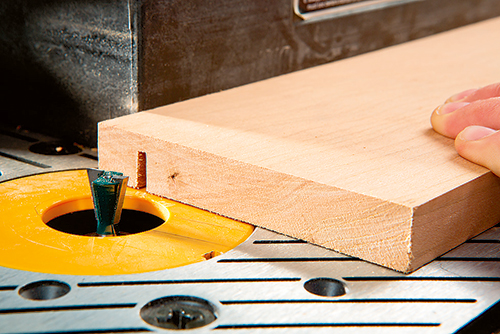 Routing hinge installation location in laptop desk