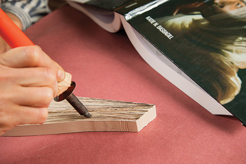 Coloring fake book lines in wood with black marker