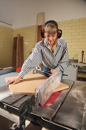 Cutting lending library roof at table saw