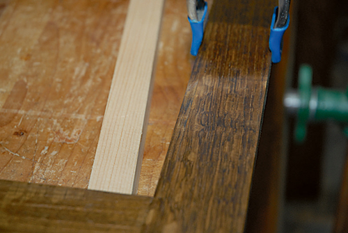 Clamping bookcase door glass strip in place