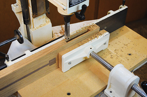 Cutting Limbert hutch leg mortises at a mortising machine