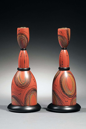 Salmon colored candlesticks with swirl design