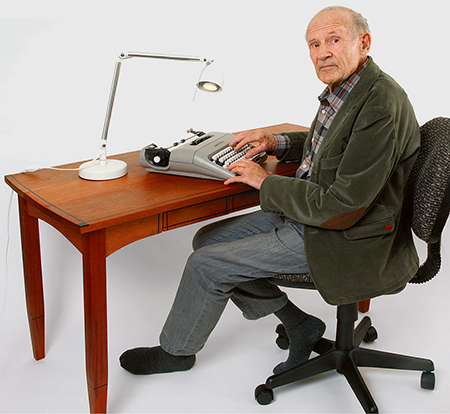 Man using typewriter at desk