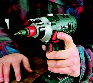 Levers on both sides of the Metabo drill let you change gears without letting go of the grip. With its chuck removed, the drill accepts a quick-change bit holder.