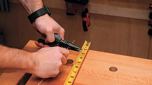 Fashioning brass pins from a cut brass rod