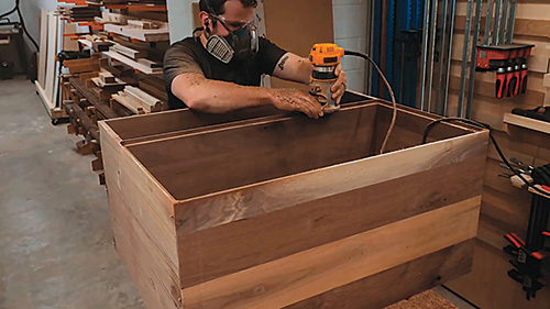 Routing rabbets in walnut for Mid-Century Modern Dresser