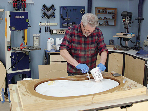 Coating kidney table panel with resin