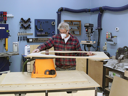Smoothing inside of epoxy mold with spindle sander