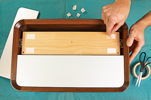 Carpet tape can help you position and hold the faces in place on the drawer boxes, so you can drill pilot holes accurately for the pull screws.