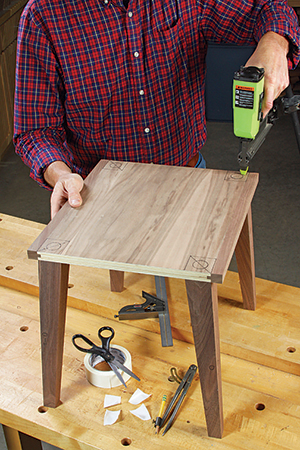 The tenon holes are easiest to drill through the bottom panel and into the legs when the parts are first assembled with carpet tape and brads
