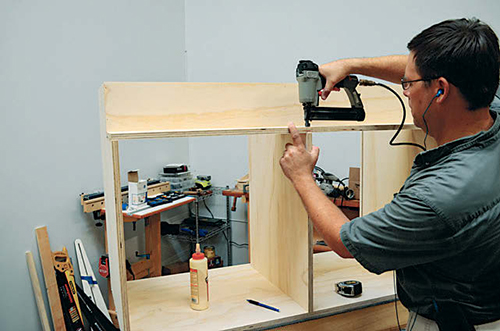 Mount the cut shelf across the sides and dividers, and nail it into place to hold it while you're driving screws.