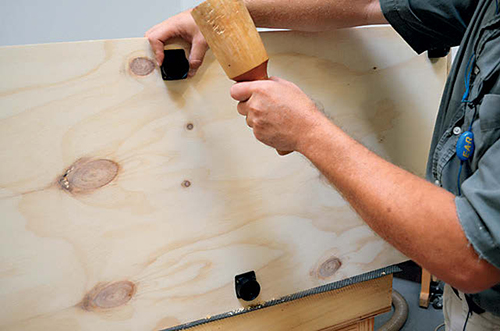 The cabinets sit on plastic leveling legs. Mount the brackets to the underside before attaching the legs.