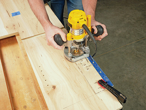 Cutting shelf pin holes in miter saw station