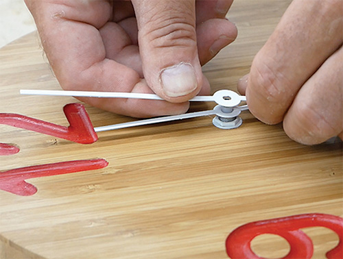 Installing clock hands onto finished face