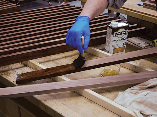 Applying WATCO oil to modern coffee table slats