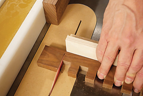 Making final cuts on modern coffee table slat at a table saw