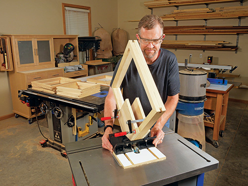 Running leg frame through router to cut splines