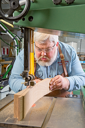 Using band saw to cut curved chair part on steam bent board
