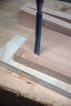 Chopping half-lap pocket out of console with a chisel